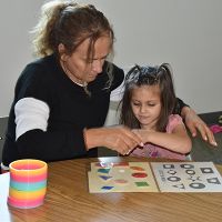 Autistic child working with autism service provider